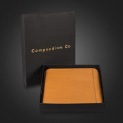 Compendium Co. tan compendium in premium black gift box with gold logo