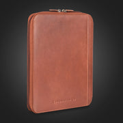 Compendium Co. dark brown leather compendium closed, standing on dark background