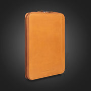  Compendium Co. tan leather compendium closed, standing on dark background