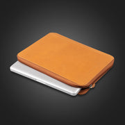  Compendium Co. tan folder closed with laptop partially zipped inside